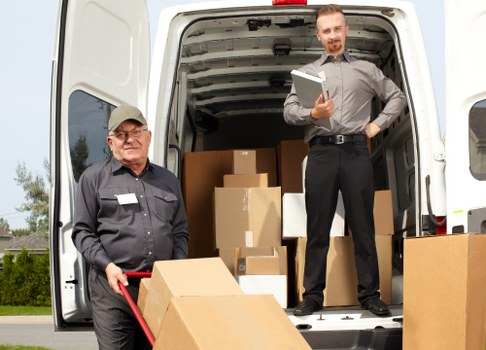Man and van moving furniture on a residential street in Osidge