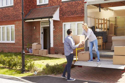 Business moving boxes and office equipment prepared for a commercial move in Osidge