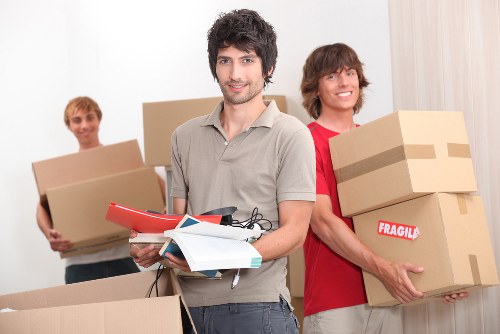 Moving team unloading boxes and furniture at a new home