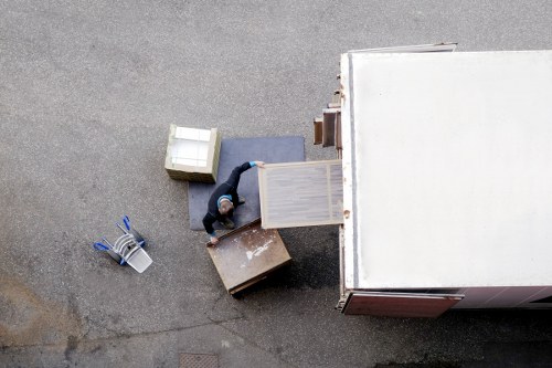 Removal team loading household items into a van