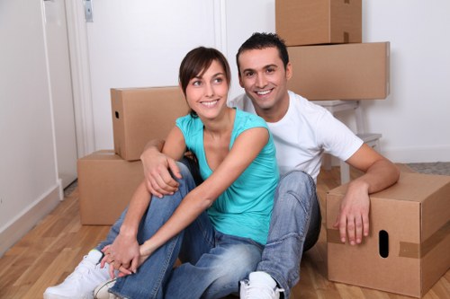 Packed boxes and furniture being loaded into a moving truck