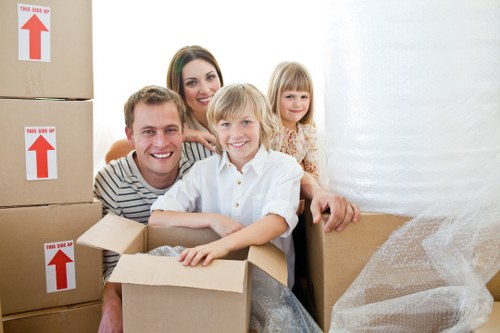 Professional movers loading household items into a van