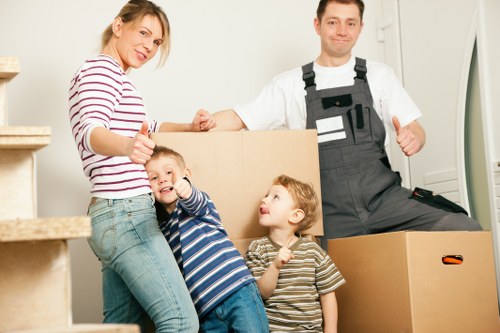 Packed moving boxes and furniture ready for transport in a North London home